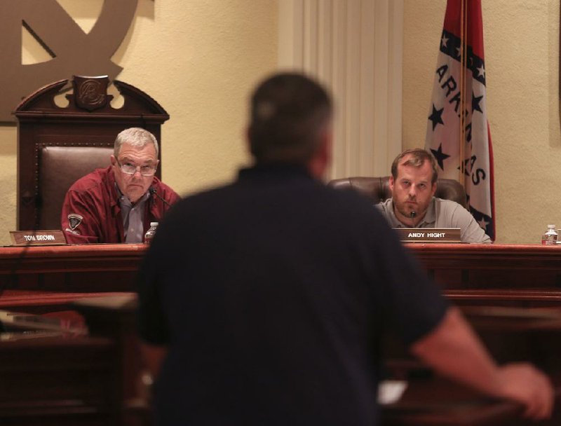  Arkansas Democrat-Gazette/STATON BREIDENTHAL --7/31/14-- North Little Rock Board of Adjustment members Tom Brown (left) and Andy Hight (right) listen as Koy Butler answers questions for the board Thursday during a meeting at City Hall. Butler was asking the board for approval to locate a business that provides care for disabled people in a home at 4404 Arlington Drive in the Lakewood area of North little Rock. 