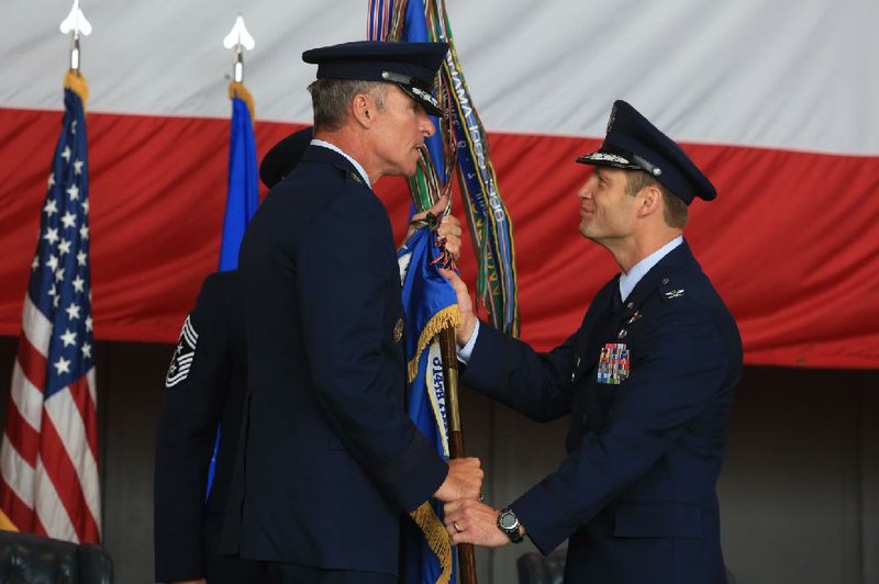 Arkansas Democrat-Gazette/RICK MCFARLAND--07/31/14--   Col. James Dryjanski (right), the new commander for the 314th Airlift Wing, accepts the guidon, that represents the wing and its commanding officer, from Maj. Gen. Michael Keltz, during a change of command ceremony at the Little Rock Air Force Base in Jacksonville Thursday. Dryjanski is taking over for Col. Scott Brewer who is going to Washington D.C. to work in Air Force headquarters.