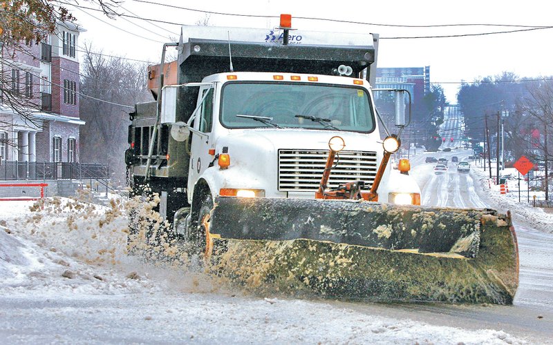 FILE PHOTO DAVID GOTTSCHALK A snow plow clears School Street in south Fayetteville on Feb. 4.