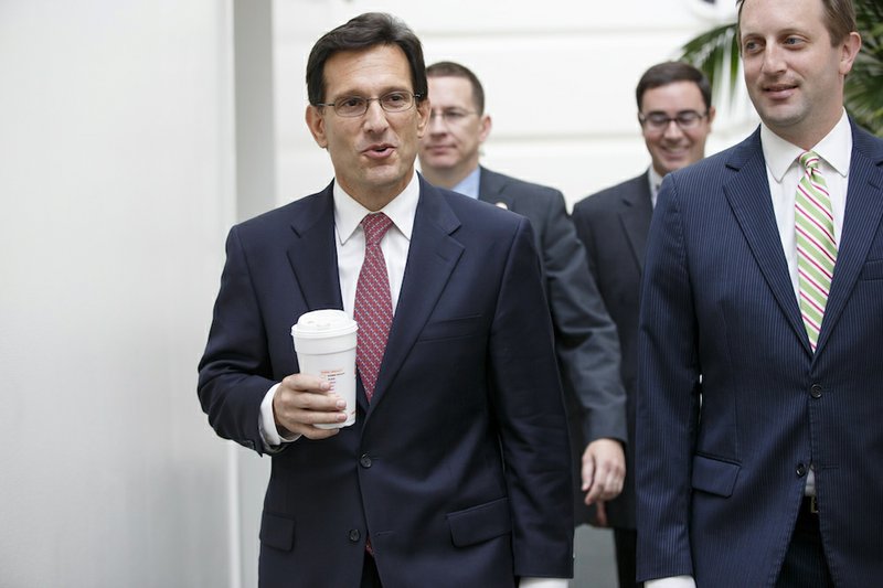 House Majority Leader Eric Cantor of Va., left, arrives for a House Republican strategy session on Capitol Hill in Washington on Tuesday, July 29, 2014. As a result of his defeat in the Virginia primary, Cantor will relinquish his leadership post earlier than expected. 