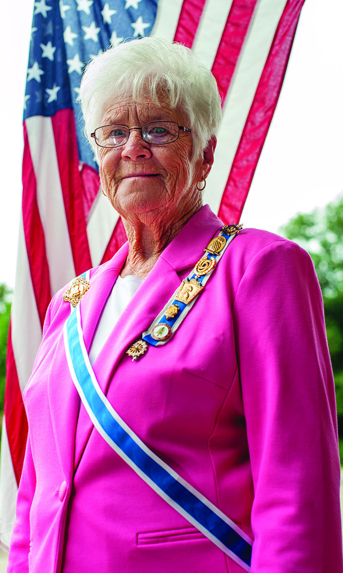 Mary Helen Love Deere, newly installed as regent of the Arkansas Society Daughters of the American Revolution, stands in front of the American flag that flies at her home in Benton. Patriotism is one of the platforms of the National Society Daughters of the American Revolution.