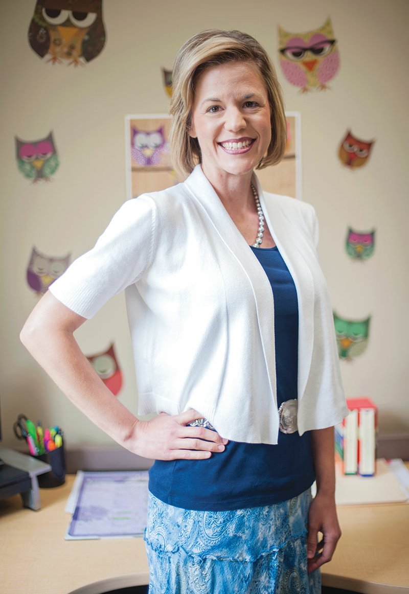 Feather Linn, education manager for ArkansasIDEAS at the Arkansas Educational Television Network in Conway, stands in her office, which is decorated with one of her favorite motifs — owls. A former public-school teacher, Linn has written a book, Pickle Juice, Diamonds and Football. Her next book signing will be from 2-4 p.m. Saturday at Hastings in Searcy.