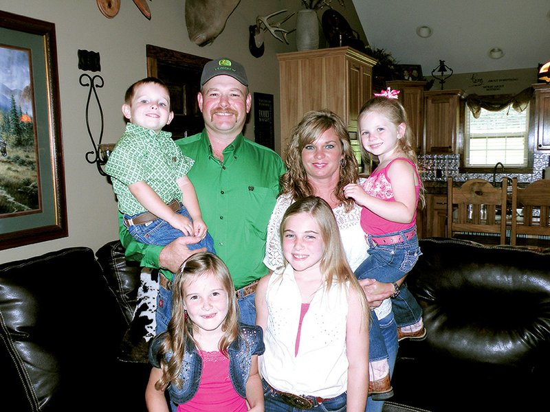 The David Pankey Jr. family is the 2014 Independence County Farm Family of the Year. Family members are, front row, from left, Emilee, 6, and Allie, 8; and back row, David and Tiffany Pankey holding, respectively, 4-year-old twins Bradley and Shelby.