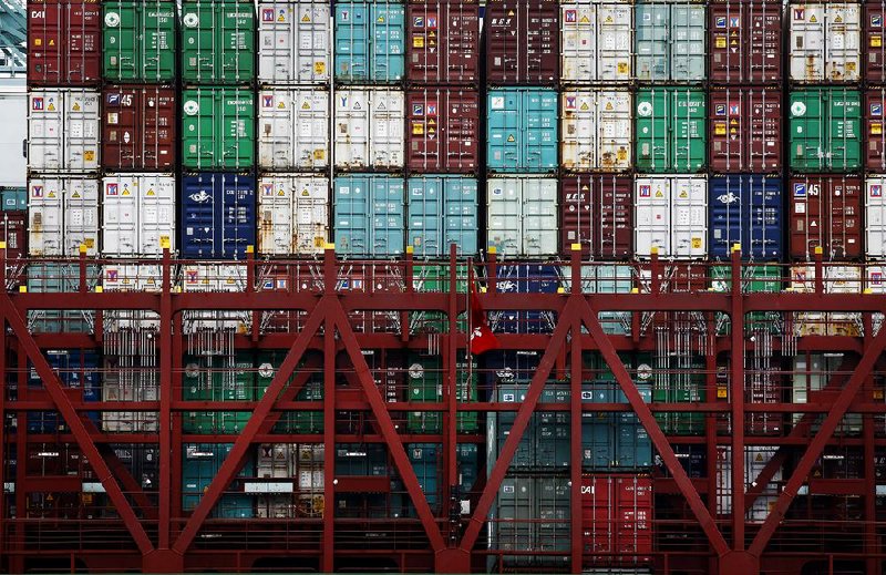 Shipping containers sit stacked on the CSCL Bohai Sea container ship as it is unloaded at the Port of Los Angeles in San Pedro, California, U.S., on Monday, June 30, 2014. A six-year labor contract expiring between about 20,000 dockworkers and 29 West Coast ports threatens to disrupt trade as negotiators scramble to forge an agreement on salaries and health-care costs. Photographer: Patrick T. Fallon/Bloomberg