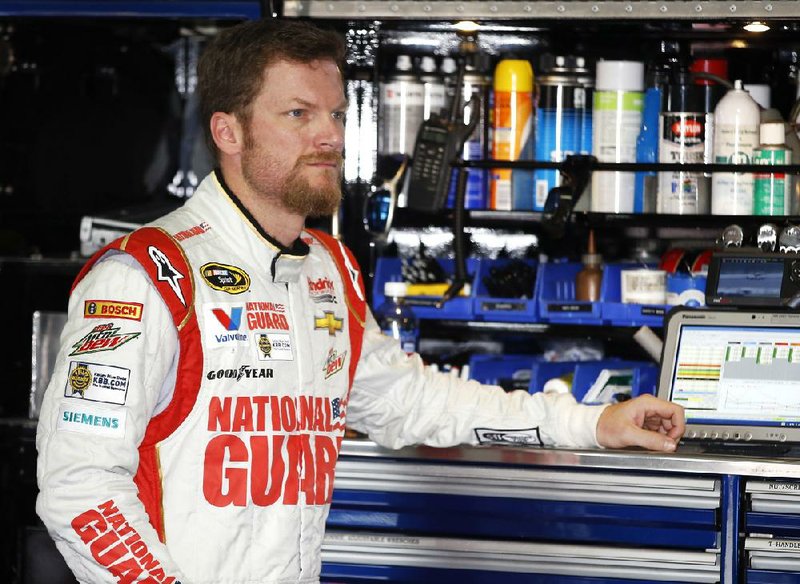Dale Earnhardt Jr. waits in the garage stall as his car is adjusted during a practice session for Sunday's NASCAR Sprint Cup Series auto race at Pocono Raceway, Friday, Aug. 1, 2014, in Long Pond, Pa. (AP Photo/Matt Slocum)