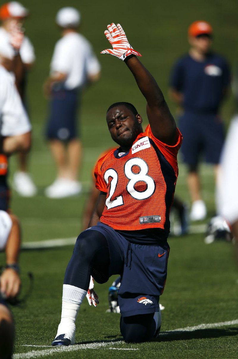 Denver Broncos'  Montee Ball stretches during the first day of NFL football training camp on Thursday, July 24, 2014, in Englewood, Colo. (AP Photo/Jack Dempsey)