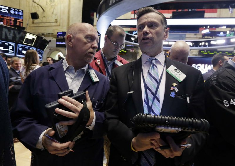 Trader John Doyle, left, and Neil Catania confer on the floor of the New York Stock Exchange Friday, Aug. 1, 2014.  U.S. markets steadied on Friday a day after a major sell-off. Investors focused on a relatively strong jobs report, which showed the U.S. economy created 209,000 jobs in July, the sixth straight month of job growth above 200,000. (AP Photo/Richard Drew)