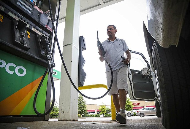 8/1/14
Arkansas Democrat-Gazette/STEPHEN B. THORNTON
Jose Quintanilla, owner of JQ Painting and Remodeling, replaces the hose after filling his work truck for $3.29 a gallon at a Mapco station at John F. Kennedy Blvd. and D Ave. in North Little Rock Friday afternoon.