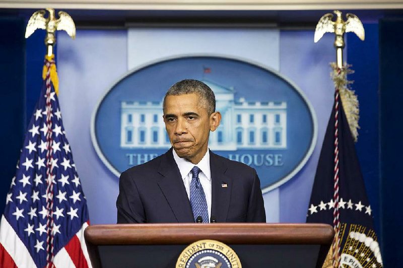 President Barack Obama pauses while speaking about various topics including the situation in the Middle East, Friday, Aug. 1, 2014, in the Brady Press Briefing Room of the White House in Washington. (AP Photo/Jacquelyn Martin)