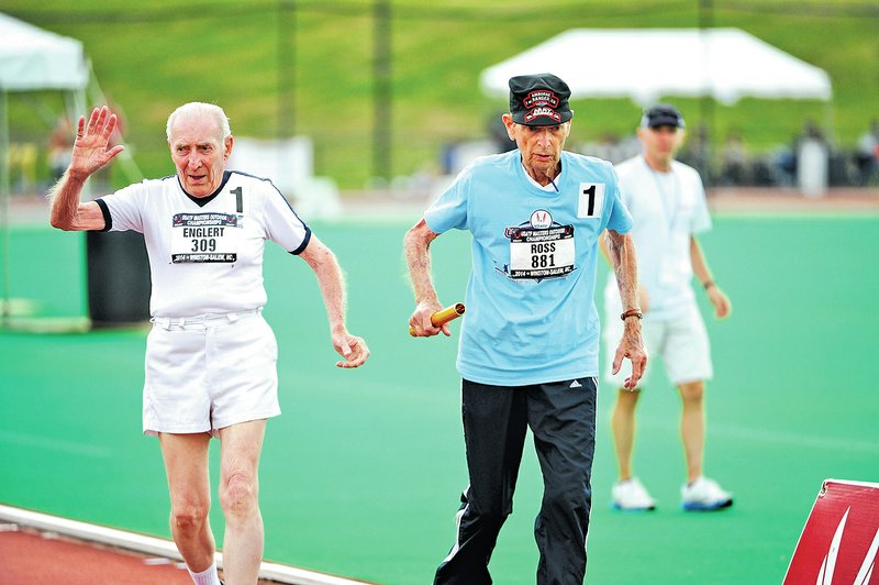 Courtesy Photo Charles Ross, right, takes the baton during a relay at the USA Track and Field Masters Championships last month in North Carolina.