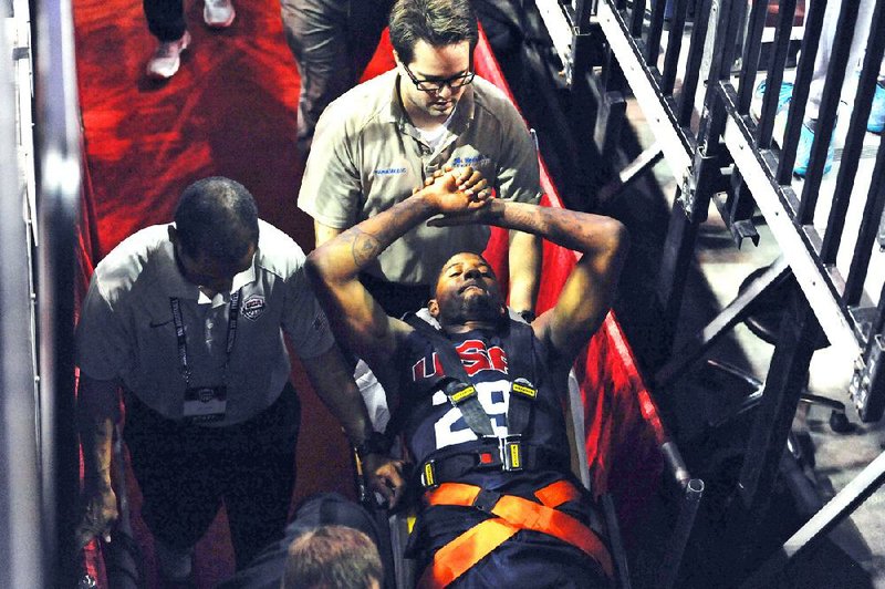 In this photo provided by the Las Vegas News Bureau,  Indiana Pacers' Paul George is carted off the court after breaking his right leg during the USA Basketball Showcase intrasquad game in Las Vegas on Friday, Aug. 1, 2014. (AP Photo/Las Vegas News Bureau, Glenn Pinkerton)