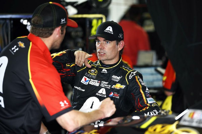 Jeff Gordon, right, talks with a crew member after a practice session for Sunday's NASCAR Sprint Cup Series auto race at Pocono Raceway, Saturday, Aug. 2, 2014, in Long Pond, Pa. (AP Photo/Matt Slocum)