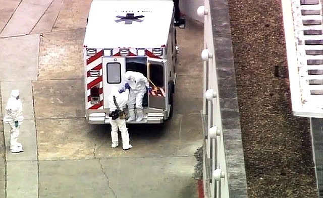 An ambulance arrives Saturday at Emory University Hospital in Atlanta with Dr. Kent Brantly (right). Brantly, who was infected with the Ebola virus in Africa, was being moved to what officials said is one of the most sophisticated isolation units in the nation.