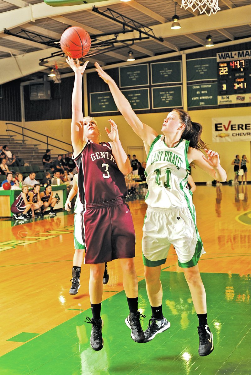 FILE PHOTO ANDY SHUPE Tara Arnold, Gentry senior guard, takes a shot in the lane as Greenland senior post Kari Scott reaches to make the block during a Dec. 4, 2012, game in Greenland. Gentry, a Class 4A school, and Greenland, a 3A school, could be in the same district if a proposal for blended conference is passed Wednesday during the Arkansas Activities Association&#8217;s meeting with the governing body in Little Rock.