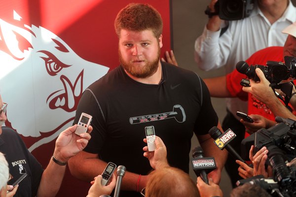 Arkansas offensive lineman Brey Cook talks to reporters as Razorback players report for fall camp Aug. 3, 2014, at the Fred Smith Center on U of A campus.