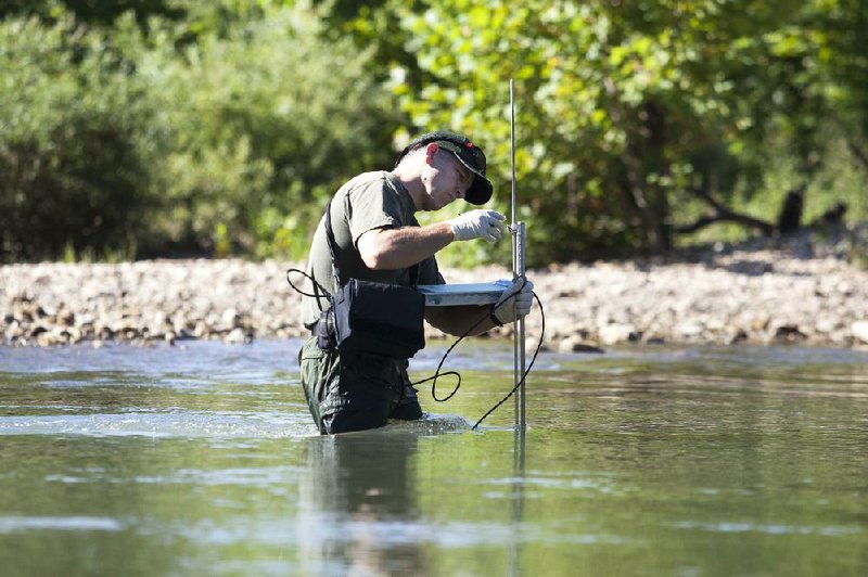 FILE PHOTO: RYAN MCGEENEY/Arkansas Democrat-Gazette --07-28-2014-- Faron Usrey, an aquatic ecologist with the Buffalo National River, collects water quality samples from the river at its confluence with Big Creek, a major tributary to the river. 
