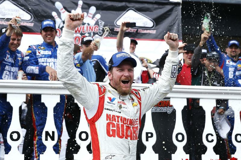 Dale Earnhardt Jr. celebrates in Victory Lane after winning the NASCAR Sprint Cup Series auto race at Pocono Raceway, Sunday, Aug. 3, 2014, in Long Pond, Pa. (AP Photo/Matt Slocum)