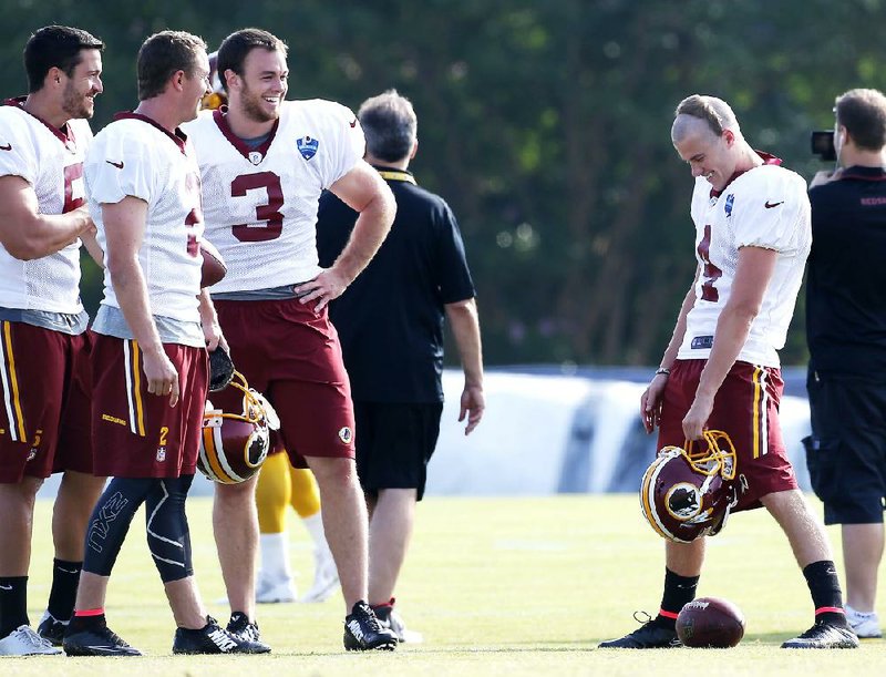 Washington Redskins' punters and kickers,  Blake Clingan, left, Kai Forbath, second from left, Robert Malone, third from left, and Zach Hocker, right, smile during practice at the Redskins training center in Richmond Va., Thursday, July 31, 2014. (AP Photo/Richmond Times-Dispatch,Mark Gormus)