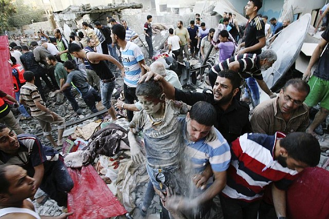 Palestinians evacuate a survivor of an Israeli air strike that hit the Al Ghoul family building in Rafah, southern Gaza Strip, Sunday, Aug. 3, 2014. At least 40 people were inside the Al Ghoul family building in Rafah Camp when it was targeted by Israeli jet fighters, according to the Red Crescent and Gaza health official Ashraf al-Kidra. Many have been confirmed dead and over two dozen have been wounded. (AP Photo/Eyad Baba)