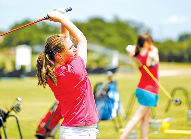 STAFF PHOTO JASON IVESTER Chloe Kordsmeier, Rogers Heritage freshman, practices on the driving range Tuesday at The First Tee of Northwest Arkansas in Lowell.