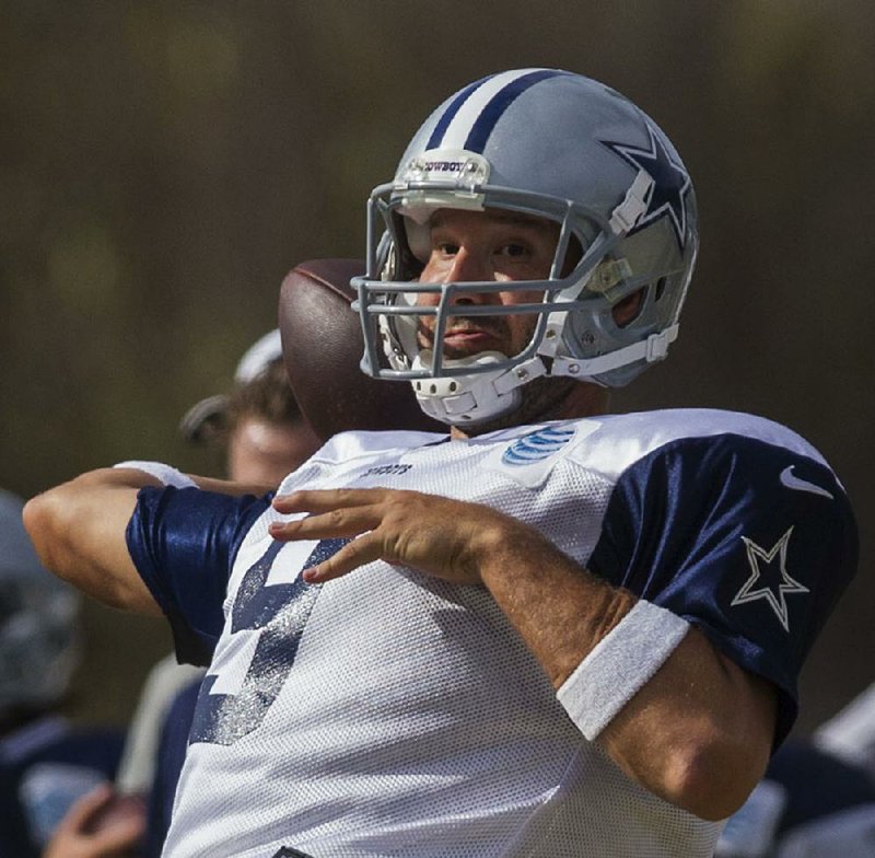 Dallas Cowboys quarterback Tony Romo (9) passes at NFL football training camp, Wednesday, July 30, 2014, in Oxnard, Calif. (AP Photo/Ringo H.W. Chiu)