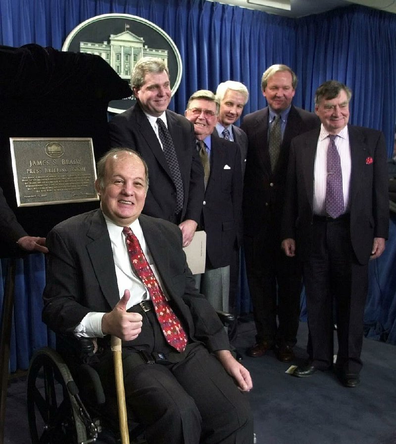 FILE - This Feb. 11, 2000 file photo shows former White House press secretary for President Reagan James Brady, left, in  a group photo following a dedication ceremony for the new James S. Brady Press Briefing Room at the White House in Washington. From left are, Brady, presidential press secretaries Joe Lockhart (Clinton), Jerald terHorst (Ford), Larry Speakes (Reagan), Mike McCurry (Clinton) and Pierre Salinger (Kennedy).  A Brady family spokeswoman says Brady has died at 73. (AP Photo/Susan Walsh/File)