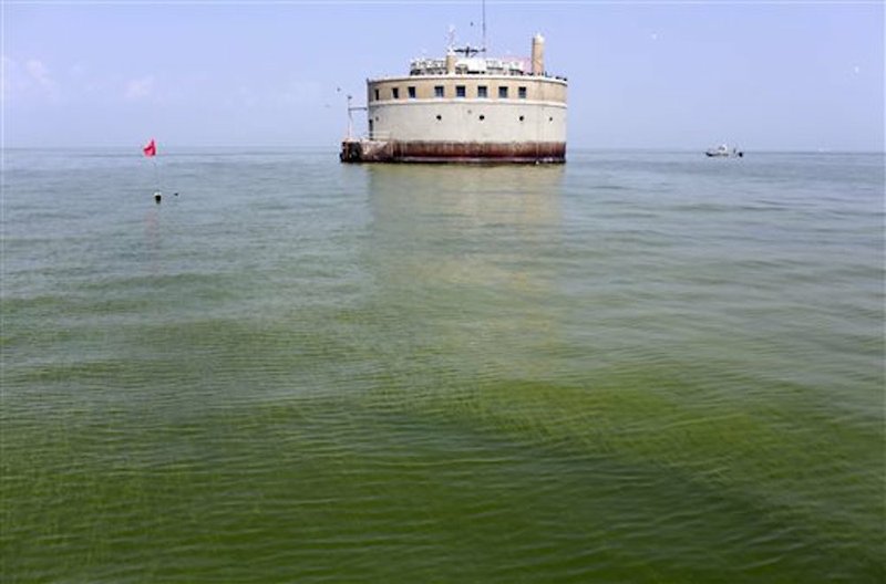 The City of Toledo water intake crib is surrounded by algae Sunday, Aug. 3, 2014, in Lake Erie, about 2.5 miles off the shore of Curtice, Ohio. 