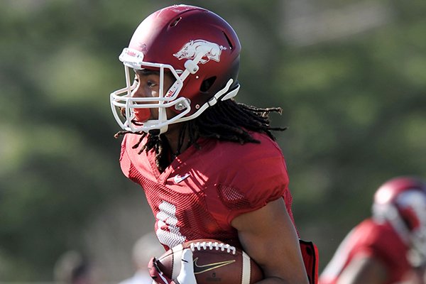 Arkansas receiver Keon Hatcher runs drills during a practice Thursday, March 20, 2014 in Fayetteville. 