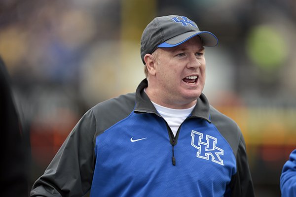 In this Nov. 16, 2013 file photo, Kentucky head coach Mark Stoops watches from the sideline in the second quarter of an NCAA college football game against Vanderbilt in Nashville, Tenn. (AP Photo/Mark Humphrey, File)