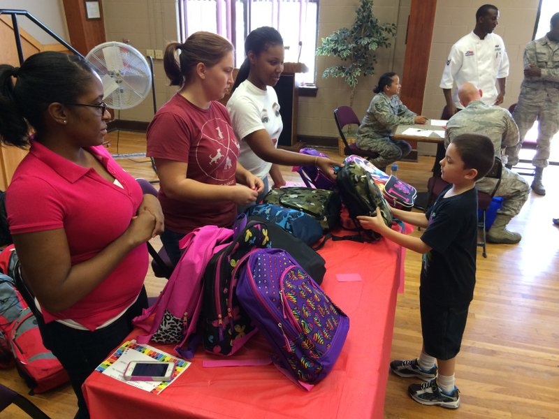 Xander McCormick, 7, chooses a backpack during Tuesday's Back-To-School-Brigade event, hosted by Operation Homefront at the Little Rock Air Force Base. Two hundred seventy-six backpacks were given away at the event.