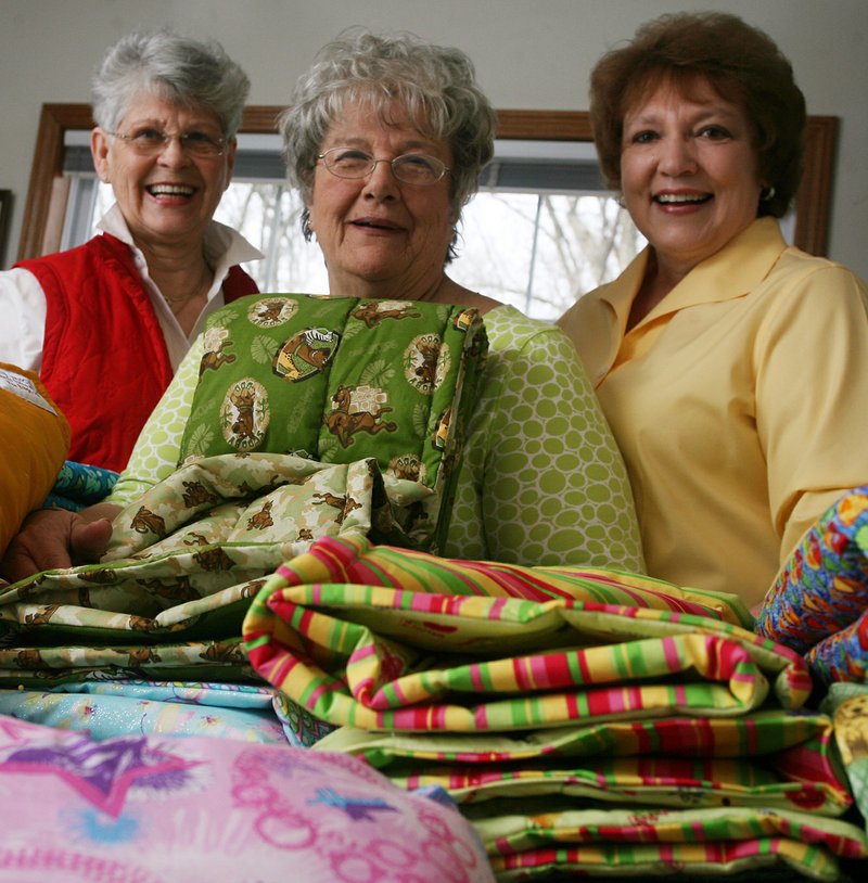 File photograph Granny&#8217;s Quilts of Love members, from left: Winona Woods, Mary Margaret Webb and Donna Beaver posed for a portrait Thursday, Feb. 25, 2010, at the home of Winona Woods in Pea Ridge.