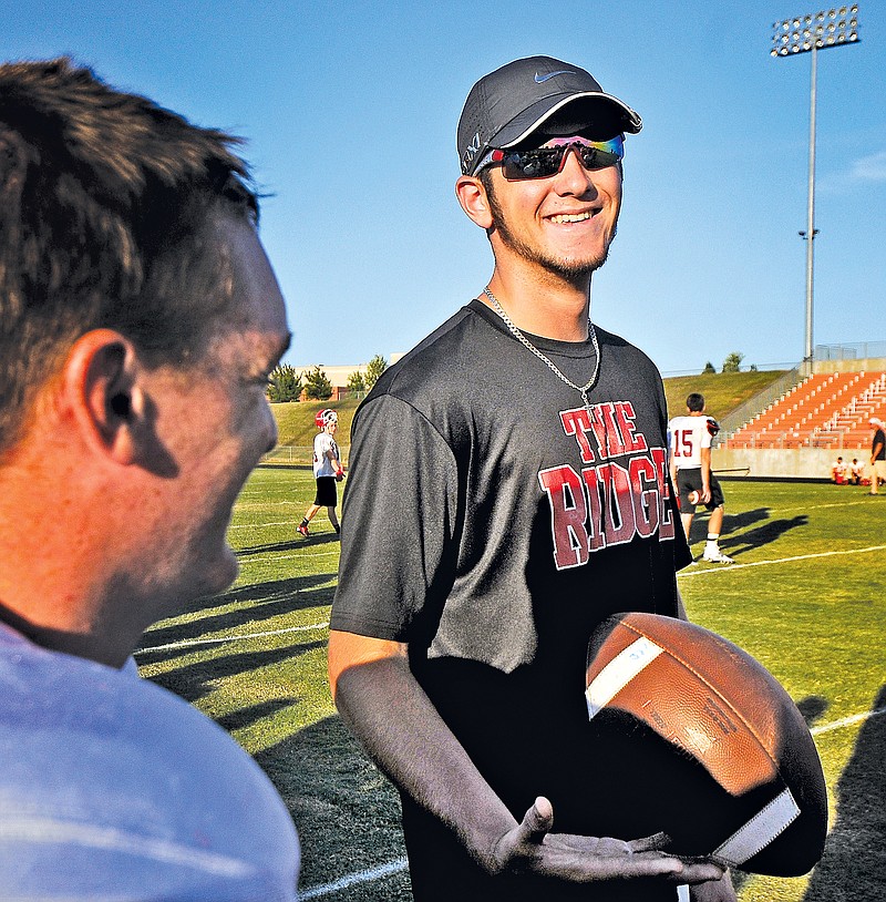 STAFF PHOTO BEN GOFF @NWABenGoff Tristan Trundle, Pea Ridge tight end/defensive end, shares a laugh with his teammates Monday on the sidelines during the team camp hosted by Gravette in Lions Stadium.