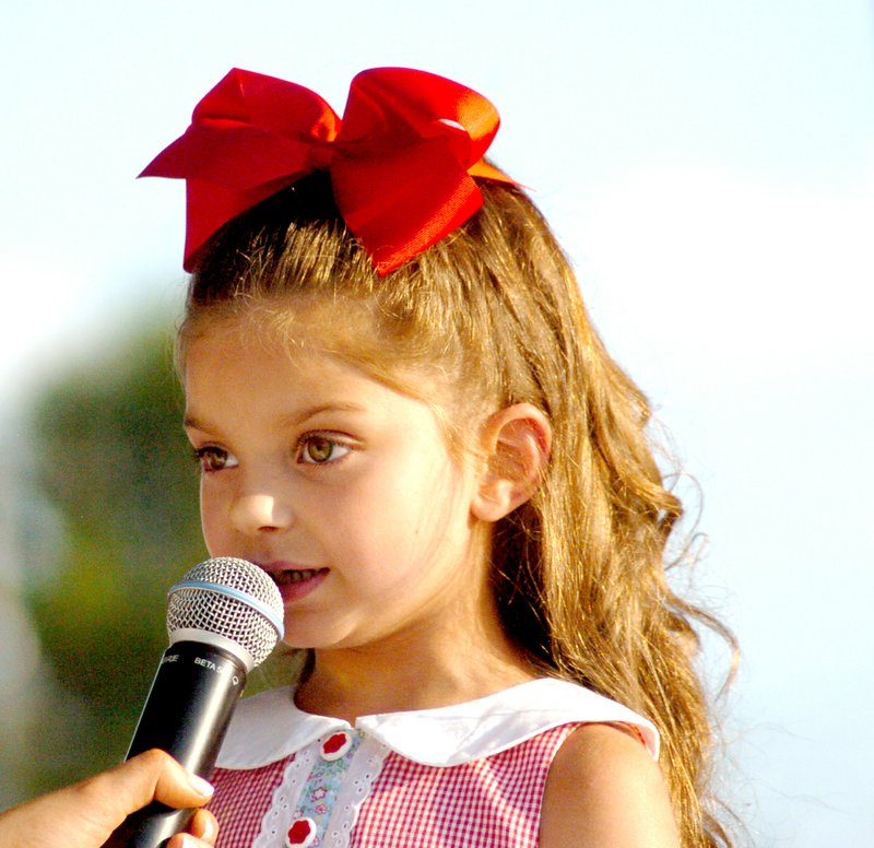 Photo by Mike Eckels Andrina Tilley, 5, performs a little song during the 2014 Decatur Barbecue Tiny Tot pageant held at Veterans Park Aug. 2. Tilley, the daughter of Savannah Tilley of Decatur, took center stage as she was interviewed by reigning Miss Decatur Barbecue, Suzanna Sikes.