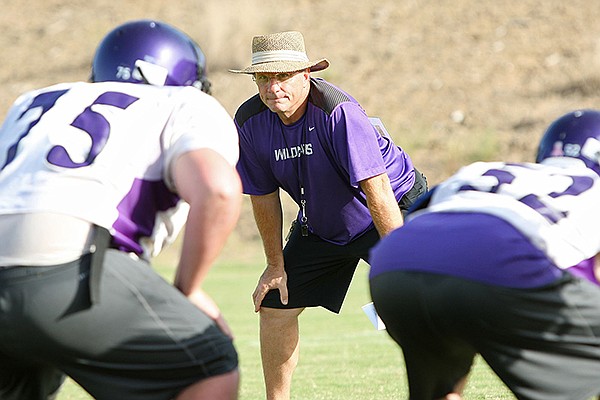 El Dorado High School head football coach Scott Reed watches his players during practice on Thursday, Aug. 9, 2013. 