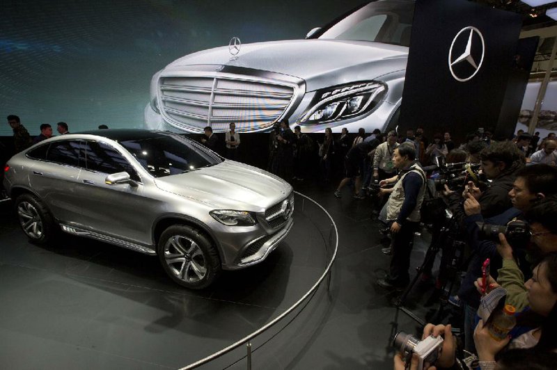 Visitors at an auto show in Beijing in April look at the latest Mercedes model. The Chinese government has initiated a series of anti-monopoly investigations that include automakers Mercedes Benz and Audi.