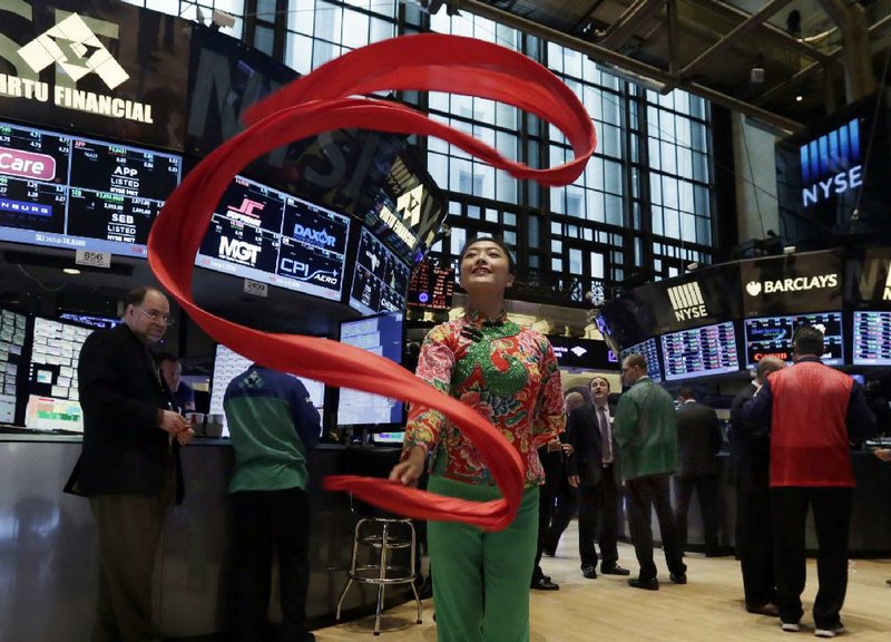 A performer demonstrates a ribbon dance Wednesday during a visit to the floor of the New York Stock Exchange to promote the 24th annual Hong Kong Dragon Boat Festival.