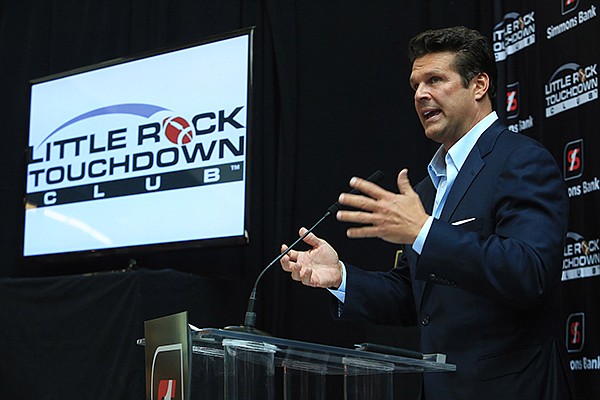 David Bazzel, president of the Little Rock Touchdown Club, announces the club's lineup of speakers Wednesday in the lobby of the Simmons Tower building in Little Rock. 