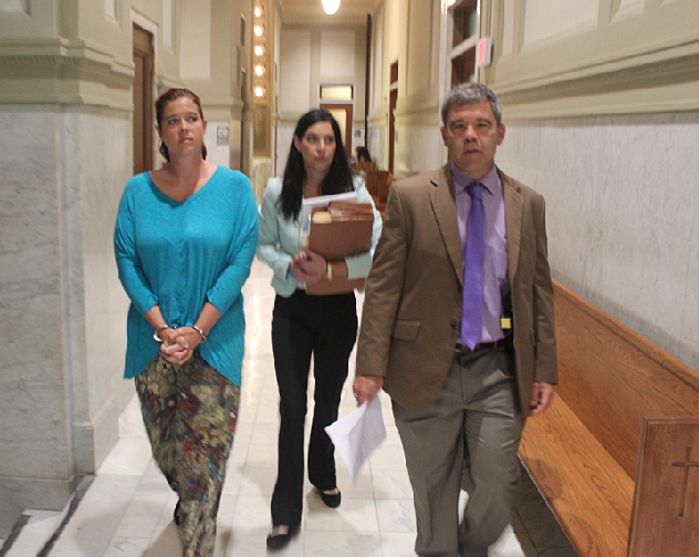 Andrea Clevenger, left, beside her attorney, Erin Cassinelli, is escorted by a bailiff from court Thursday.