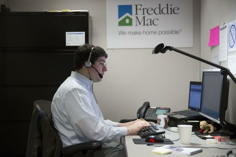 Employee John Estrada works in the borrower contact unit area at Freddie Mac headquarters in McLean, Virginia, U.S., on Tuesday, April 8, 2014. Senator Sherrod Brown, an Ohio Democrat and a member of the Senate Banking Committee, said a bipartisan bill to replace Fannie Mae and Freddie Mac is too complicated and doesn't do enough to address too-big-to-fail concerns or provide assistance for affordable housing. The panel will consider the measure on April 29. Photographer: Andrew Harrer/Bloomberg *** Local Caption *** John Estrada