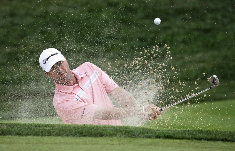 Ryan Palmer hits out of the bunker on the seventh hole during the first round of the PGA Championship golf tournament at Valhalla Golf Club on Thursday, Aug. 7, 2014, in Louisville, Ky. (AP Photo/David J. Phillip)