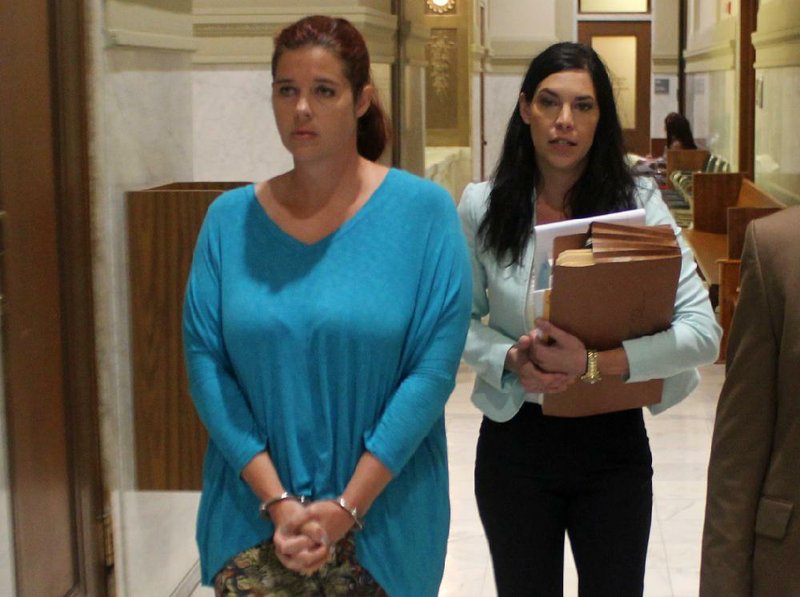Andrea Clevenger, left, walks beside her attorney, Erin Cassinelli, on Thursday, Aug. 7, 2014, at the Pulaski County Courthouse after her hearing Thursday.