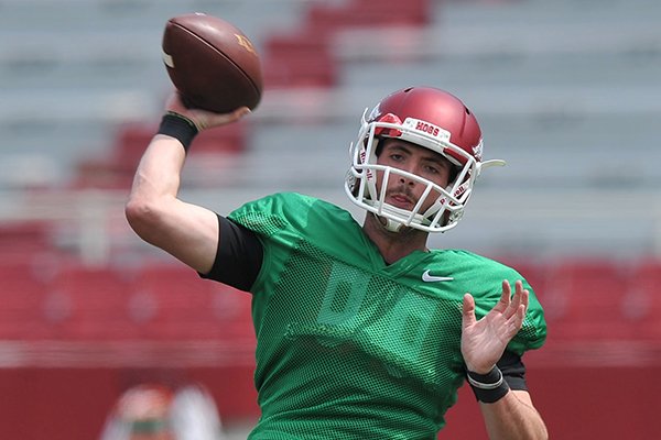 Arkansas quarterback Brandon Allen throws a pass during practice Saturday, April 12, 2014 at Razorback Stadium in Fayetteville. 