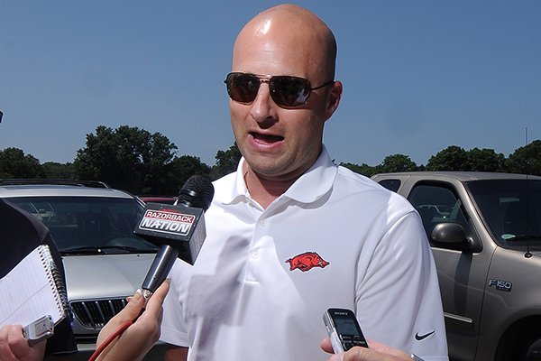 Barry Lunney, Jr., Arkansas tight end coach, speaks to the media prior to the George Billingsley NWA Razorback Club Celebrity Scramble golf tournament at the Kingsdale Golf Complex in Bella Vista on Friday, July 25, 2014. 