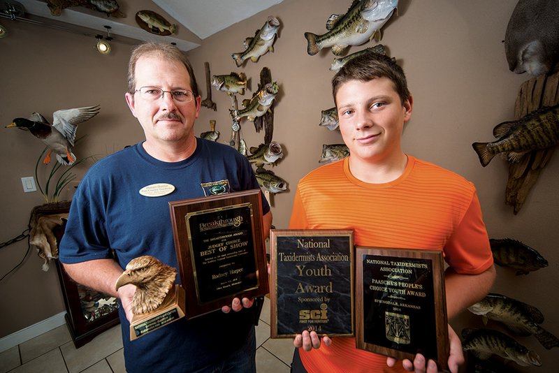 Rodney Harper and his son, Jared, are shown with some of the awards they have recently won in taxidermy
competitions.