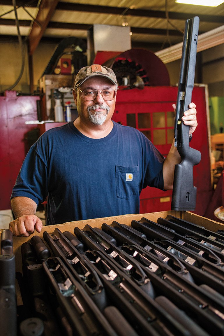 Fred Choate, president of Choate Machine and Tool in Bald Knob, holds one of the synthetic gun stocks the company makes.