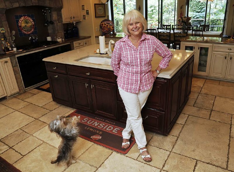 Arkansas Democrat-Gazette/JOHN SYKES JR. - Personal Space - Paula Dempsey, owner and baker at Dempsey Bakery, and her dog Annie. Her favorite space is her kitchen.