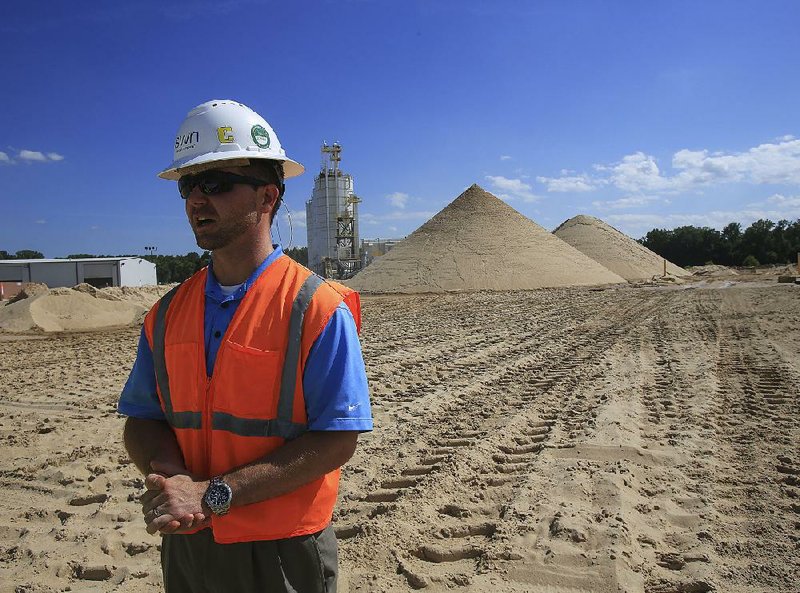  Arkansas Democrat-Gazette/STATON BREIDENTHAL --7/29/14--  Manager Britt Mitchell explains the process of mining and processing sand at the SWN Sand Company in North Little Rock. 