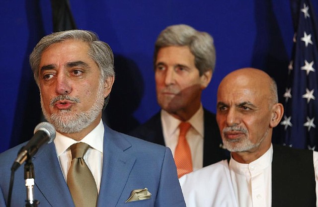 Afghan presidential candidates Abdullah Abdullah (left) and Ashraf Ghani Ahmadzai (right) join U.S. Secretary of State John Kerry at a news conference Friday in Kabul.