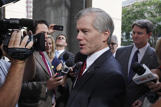 Former Virginia Gov. Bob McDonnell enters the federal courthouse in Richmond, Va., Friday, Aug. 8, 2014, where the federal corruption trial against he and former first lady Maureen McDonnell continues. One of McDonnell's attorneys, John L. Brownlee, is on the right. (AP Photo/Richmond Times-Dispatch, Bob Brown)