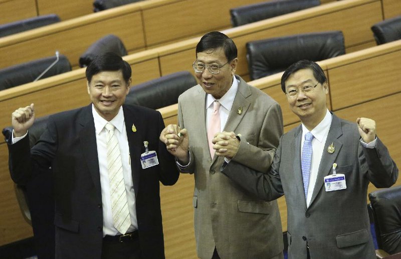 Newly elected President of the National Legislative Assembly (NLA) Pornpetch Wichitcholchai, center, poses with his two deputies Surachai Liengboonlertchai, right, and Peerasak Porchit, left, after they were voted for the positions at the meeting of the NLA at the Parliament in Bangkok, Thailand Friday, Aug. 8, 2014. In their inaugural meeting, they voted unanimously to elect former Harvard-educated Supreme Court Judge Pornpetch Wichitcholchai as the assembly president. (AP Photo/Apichart Weerawong)